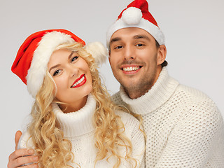 Image showing family couple in sweaters and santa's hats