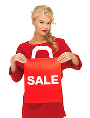 Image showing beautiful woman in red dress with shopping bag