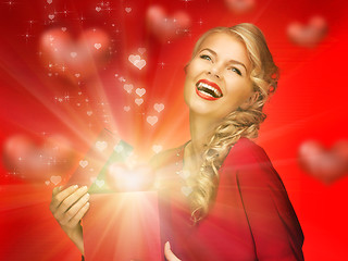 Image showing lovely woman in red dress with valentine gift box