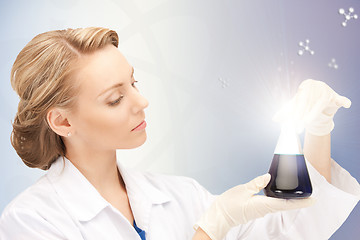 Image showing lab worker holding up test tube