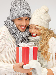 Image showing romantic couple in a sweaters with gift box