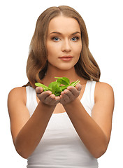 Image showing woman with spinach leaves on palms