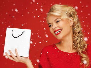 Image showing lovely woman in red dress with shopping bag