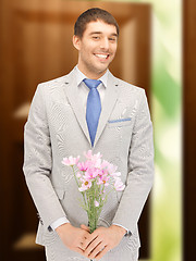 Image showing handsome man with flowers in hand