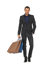 Image showing handsome man in suit with shopping bags