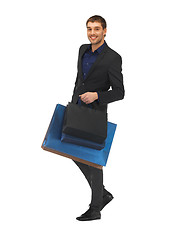 Image showing handsome man in suit with shopping bags