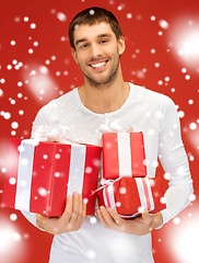 Image showing man holding many gift boxes