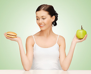 Image showing woman with hamburger and apple