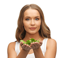 Image showing woman with spinach leaves on palms