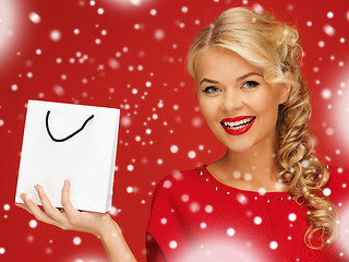 Image showing lovely woman in red dress with shopping bag