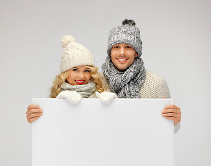 Image showing couple in a winter clothes holding blank board