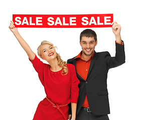 Image showing man and woman with sale sign