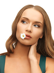 Image showing woman with camomile in mouth