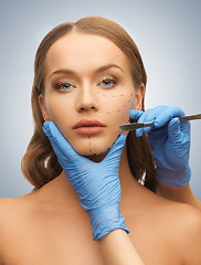 Image showing woman face and beautician hands