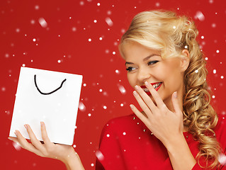 Image showing lovely woman in red dress with shopping bag