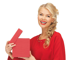 Image showing lovely woman in red dress with opened gift box