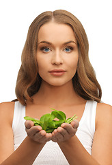 Image showing woman with spinach leaves on palms