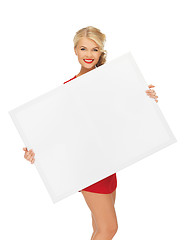 Image showing lovely woman in red dress with blank board