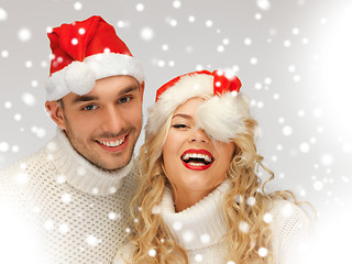 Image showing family couple in sweaters and santa's hats