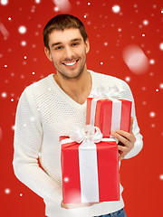 Image showing man holding many gift boxes