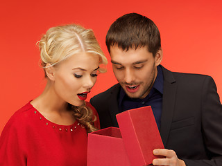 Image showing man and woman looking inside the gift box