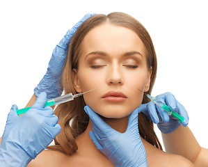 Image showing woman face and beautician hands