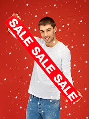 Image showing handsome man with sale sign