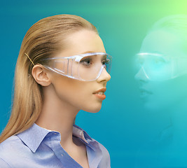 Image showing woman in 3d glasses with hologram