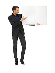 Image showing handsome man in suit with a blank board