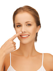 Image showing beautiful woman pointing to nose