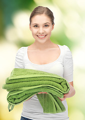 Image showing lovely housewife with towels