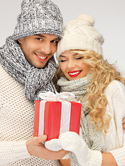 Image showing romantic couple in a sweaters with gift box