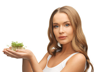 Image showing woman with green grass on palms