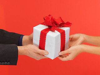 Image showing man and woman's hands with gift box