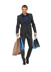 Image showing handsome man in suit with shopping bags