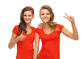 Image showing teenage girls showing thumbs up and victory sign