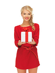 Image showing lovely woman in red dress with present