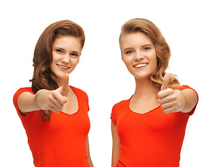 Image showing wo teenage girls in red t-shirts showing thumbs up