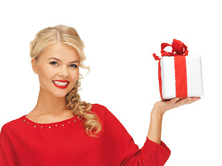 Image showing lovely woman in red dress with present