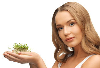 Image showing woman with green grass on palms