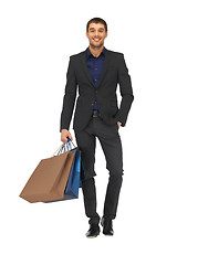 Image showing handsome man in suit with shopping bags