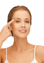 Image showing beautiful woman pointing to eyebrow