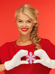 Image showing woman in mittens and red dress with snowflake