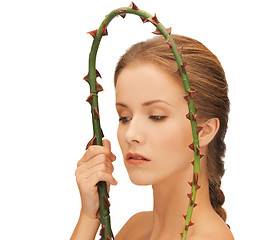 Image showing woman holding branch with thorns