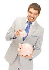 Image showing man with two piggy banks