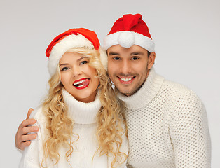 Image showing family couple in sweaters and santa's hats