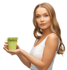 Image showing woman with green grass in pot