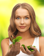 Image showing woman with spinach leaves on palms