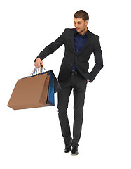 Image showing handsome man in suit with shopping bags