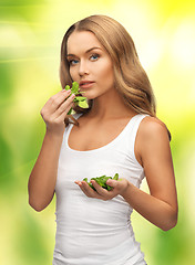 Image showing woman with spinach leaves on palms